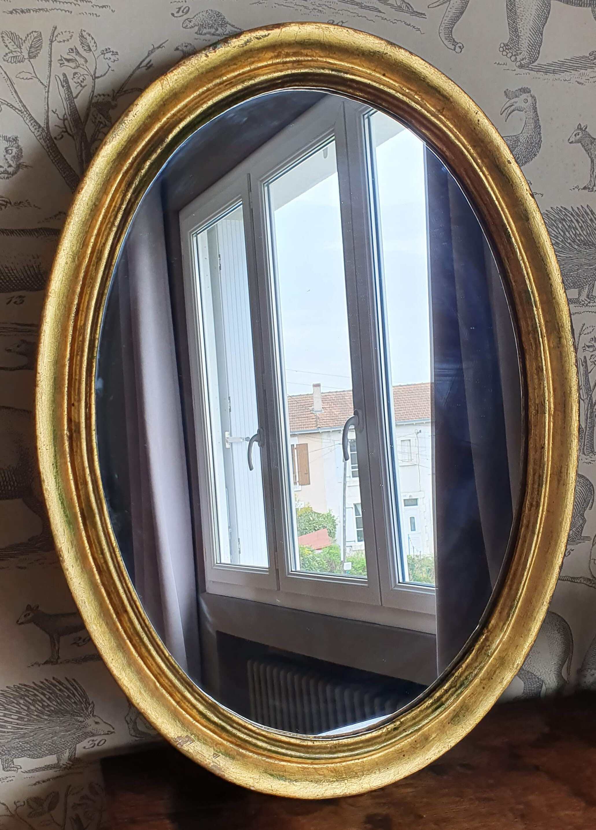Oval mirror in gilded wood 67X52