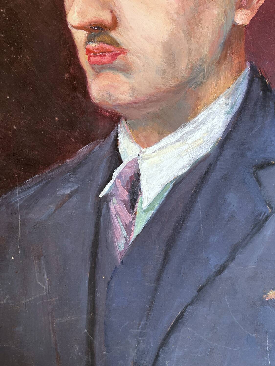 Old oil painting on cardboard portrait of a man in a blue suit