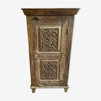 India. Bonnetière with a teak door finely carved by hand.