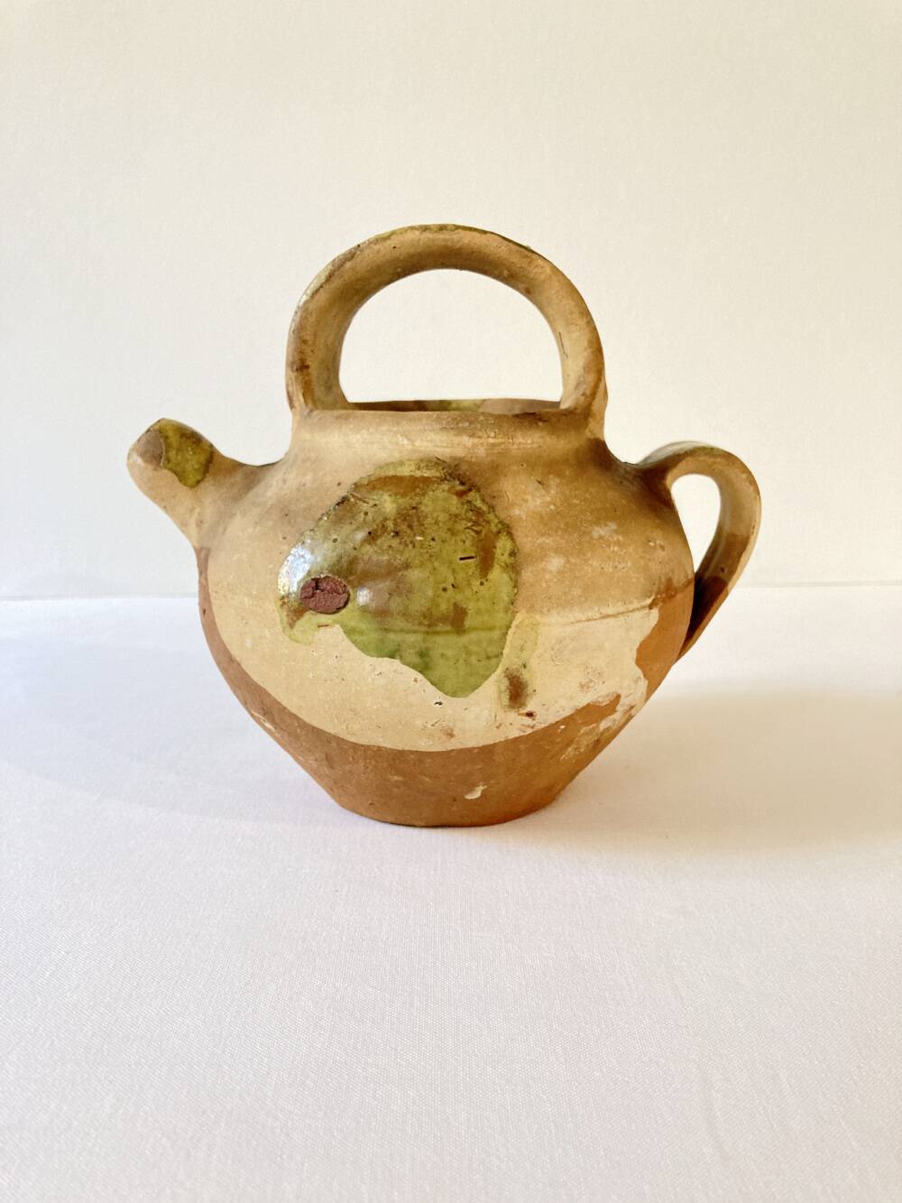 Small Provençal goat jug in creamy white and green enamelled stoneware