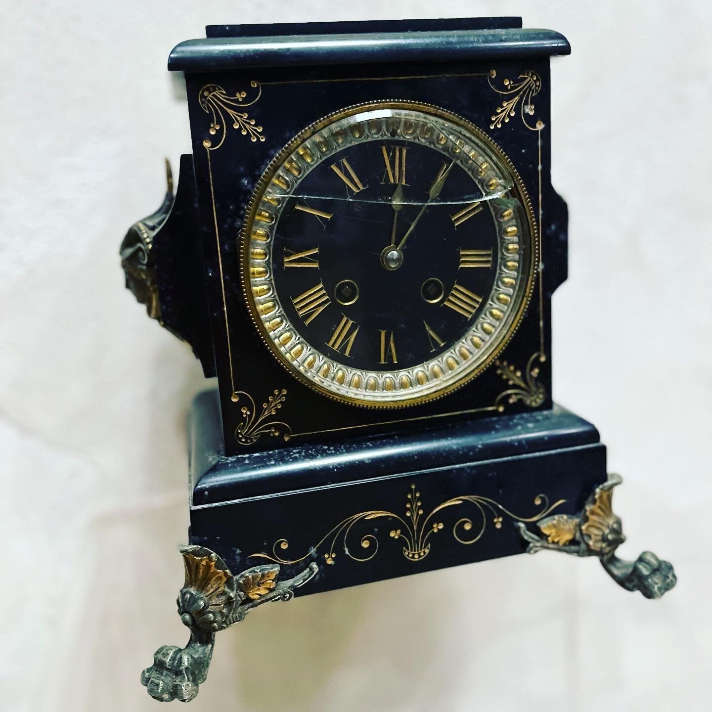 Black marble clock and brass ornament