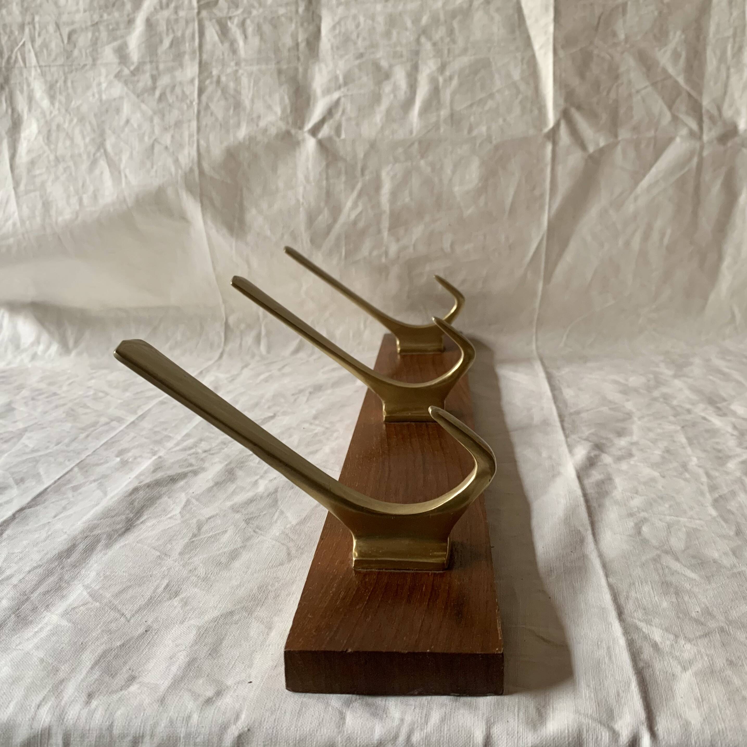 Vintage wooden wall-mounted coat rack with 3 golden cast aluminum hooks