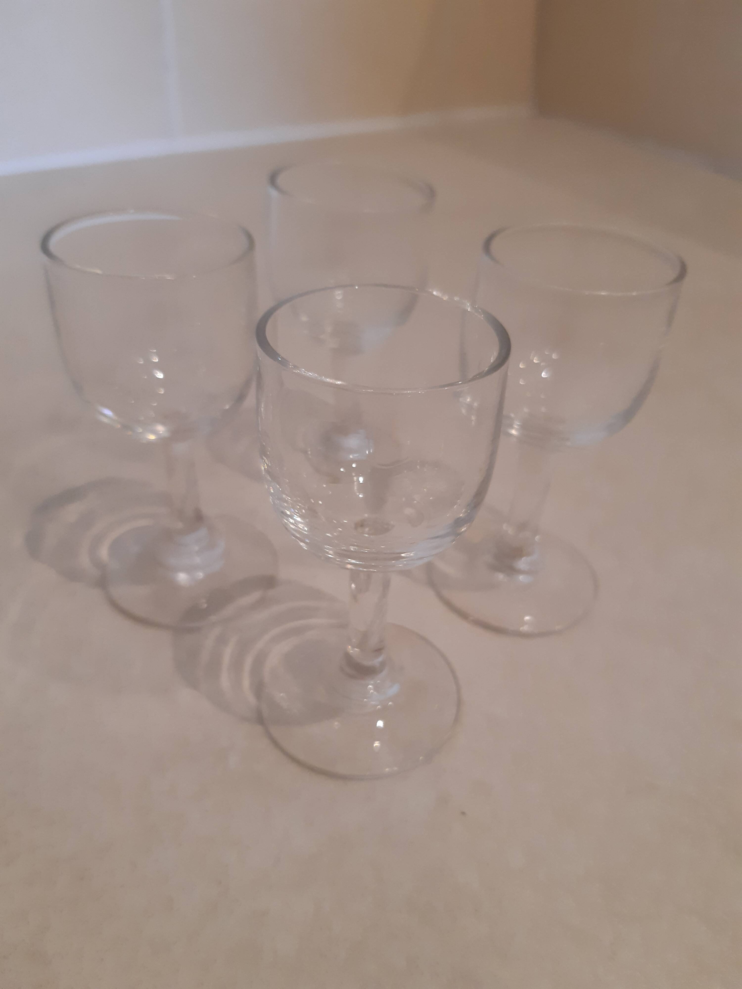 Set of 4 small stemmed glasses for strong alcohol.