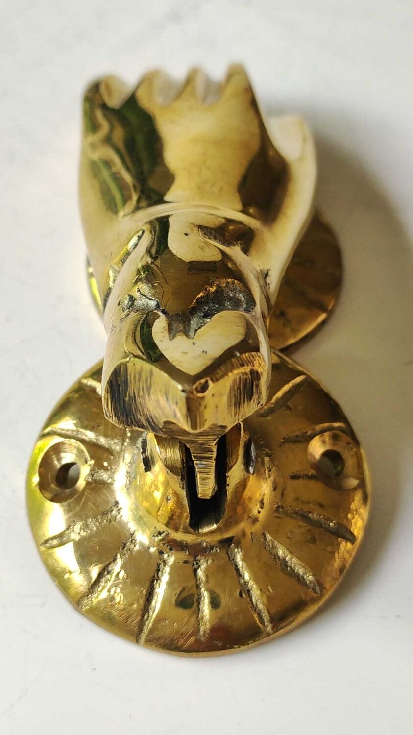 Hand-shaped door knocker. In polished brass, beautiful shine