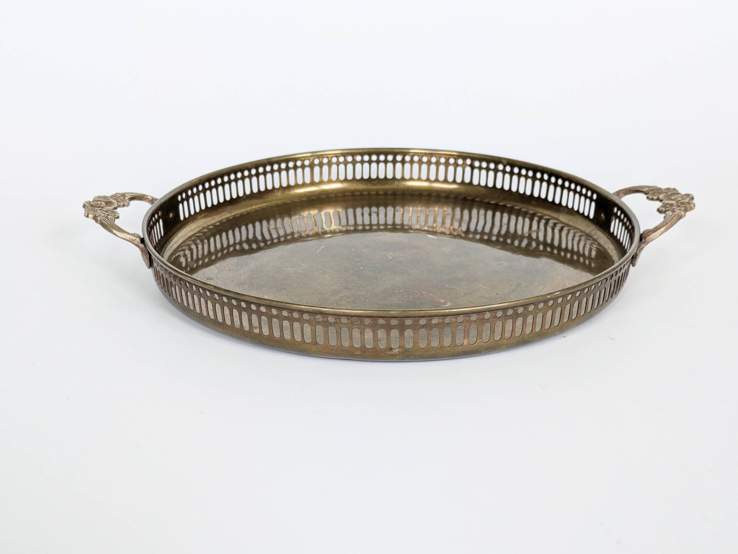 Vintage decorative brass tray, pierced edge and floral handles.