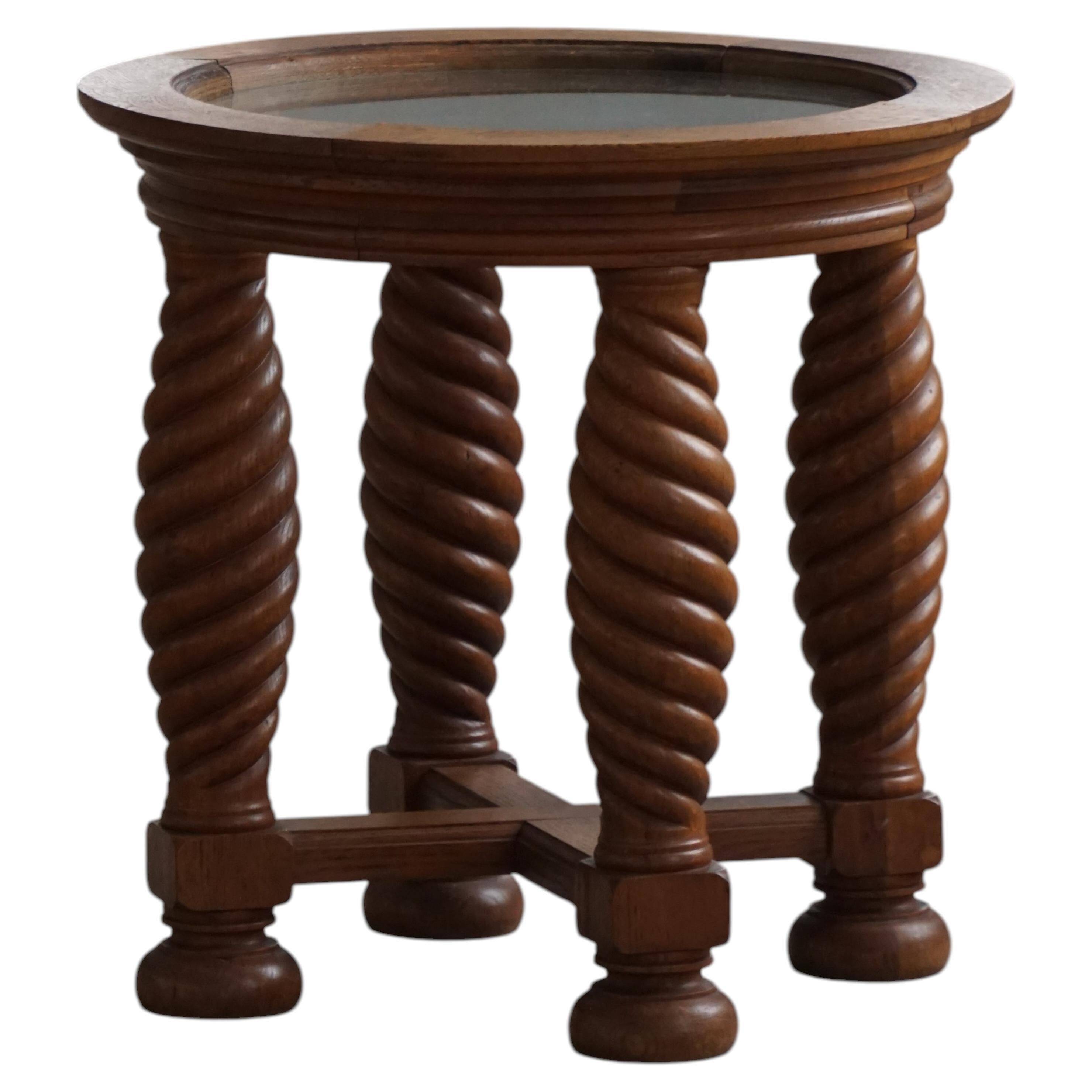 Modern Danish mid-century table, made of oak with spiral turned legs and a glass top, 1950s.