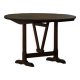 Round table with a tilting top from a 19th-century provincial French winemaker in oak.