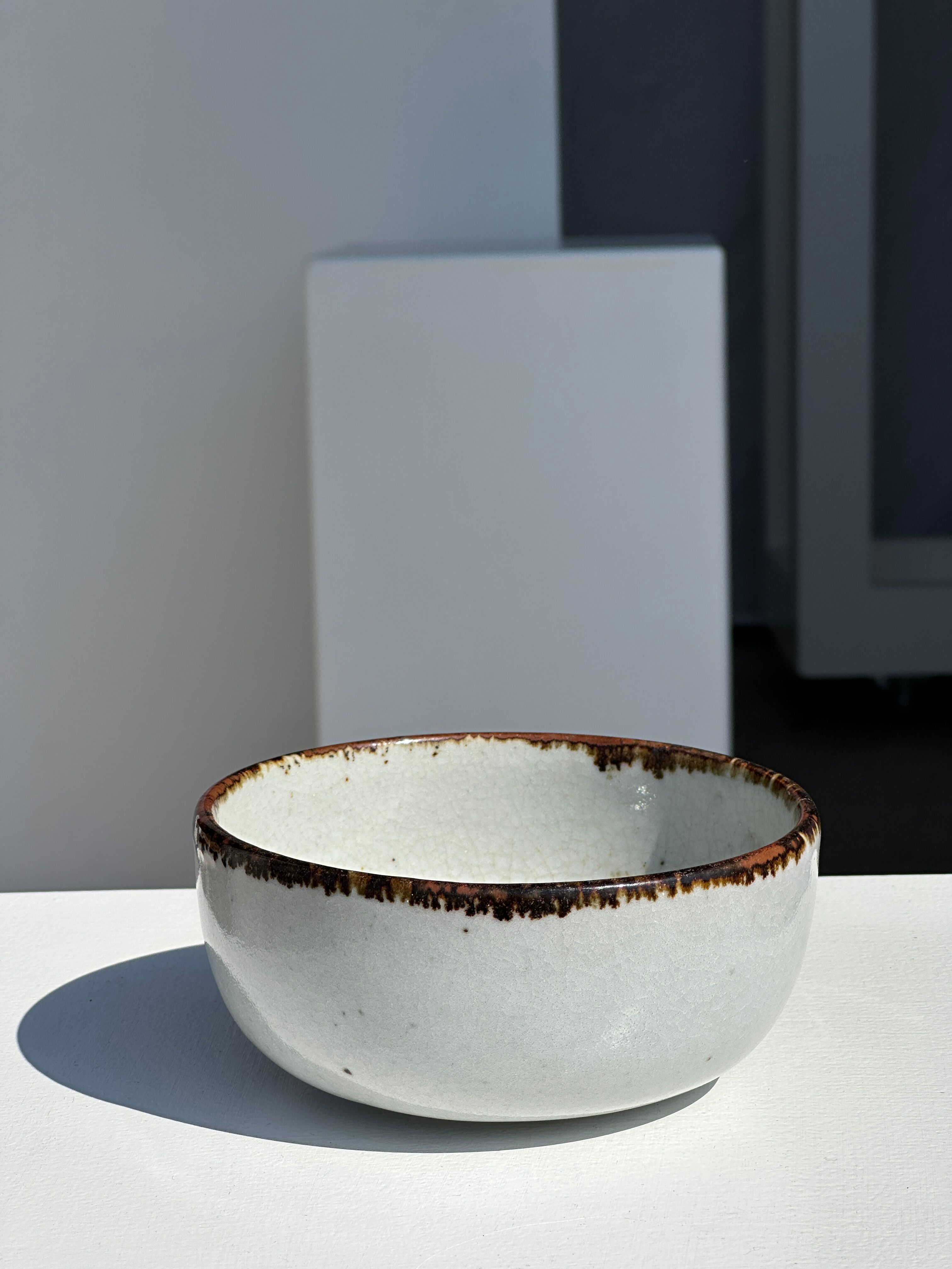 Small white glazed ceramic bowl black edges