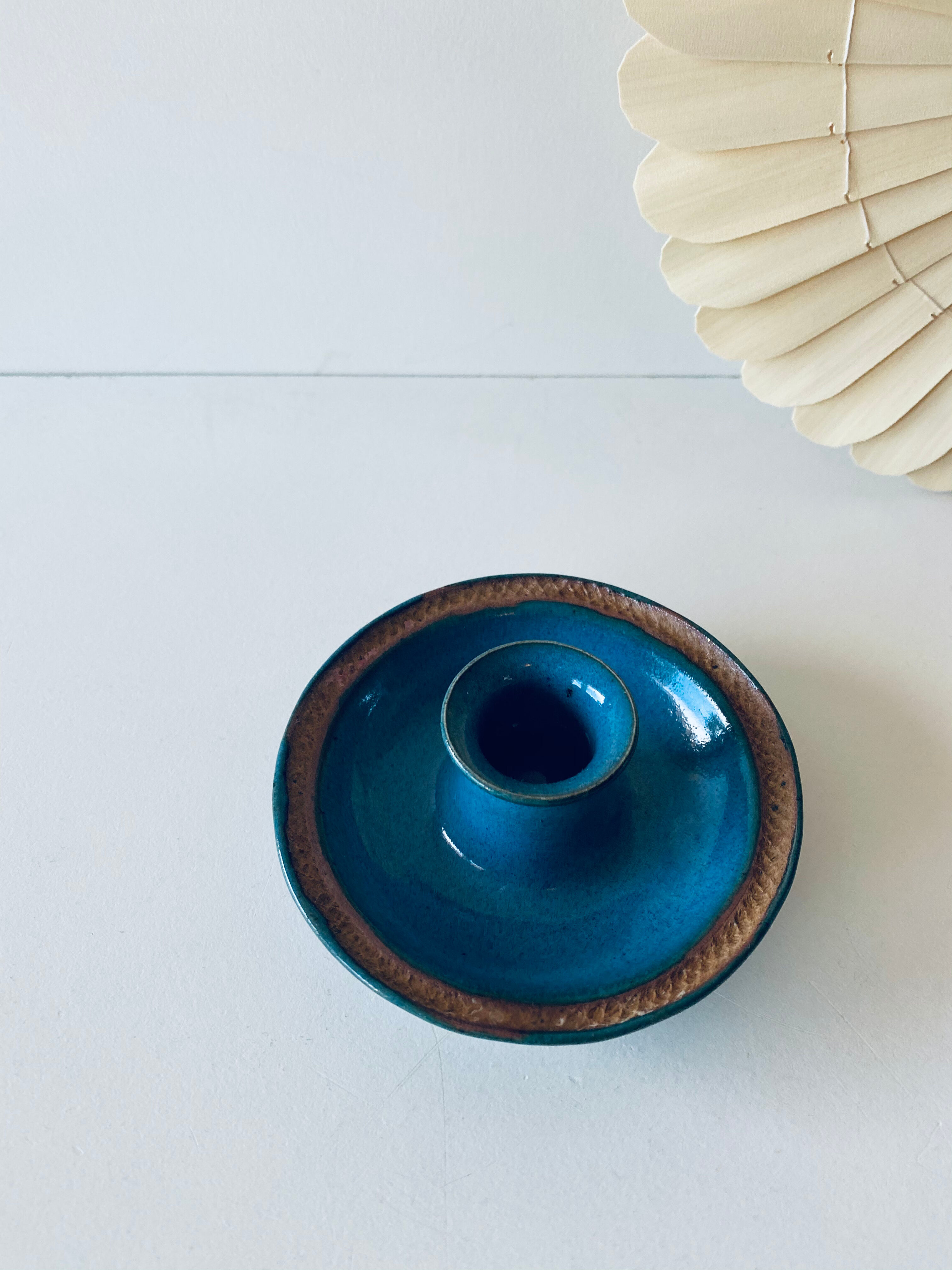 Blue enamelled sandstone candlestick