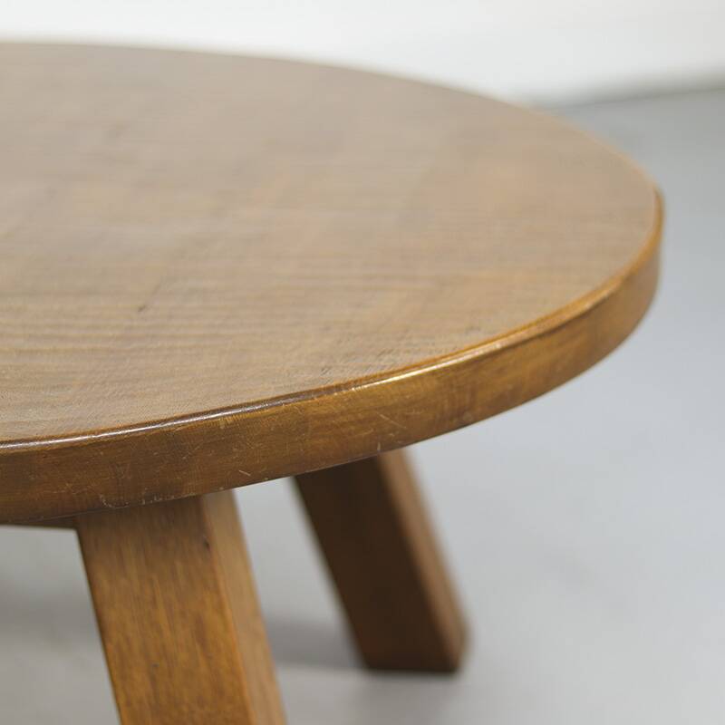 Large rustic vintage coffee table in a round brutalist style.