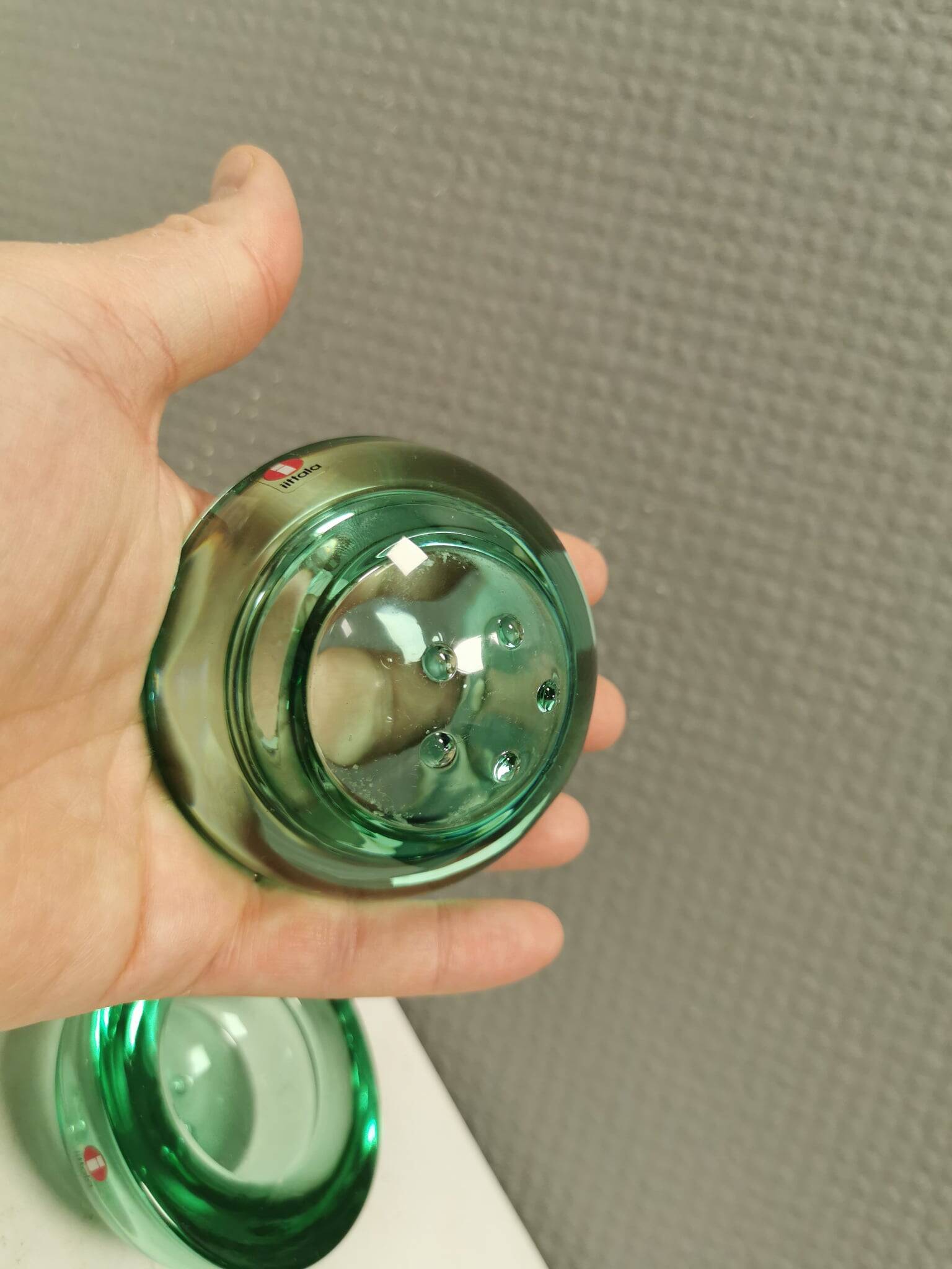 A set of iitalla candle holders in green transparent glass.