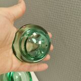 A set of iitalla candle holders in green transparent glass.