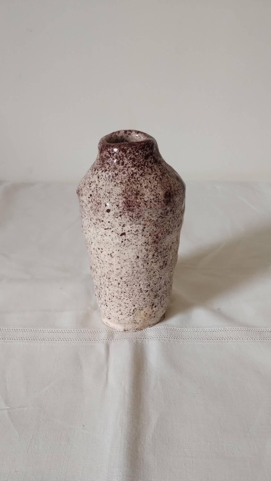 White ceramic vase with brown speckles