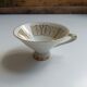 Solitaire tea cup, saucer, and dessert plate in white and gold.