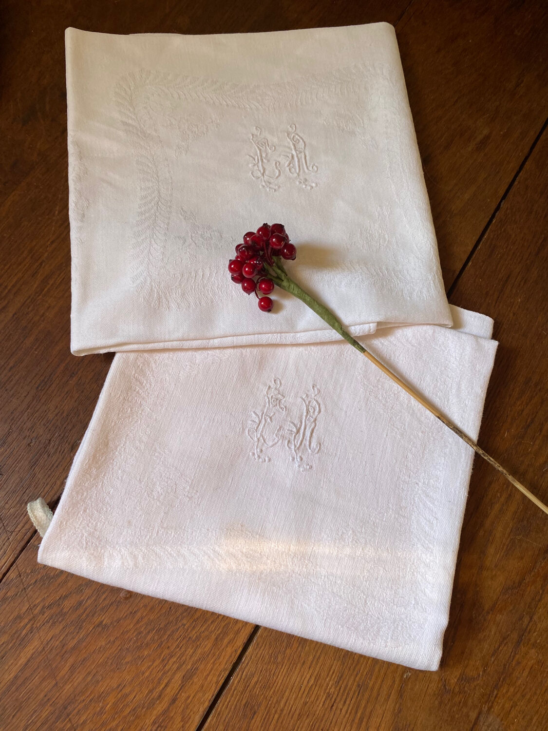 Pair of embroidered white cotton tea towels.