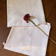 Pair of embroidered white cotton tea towels.
