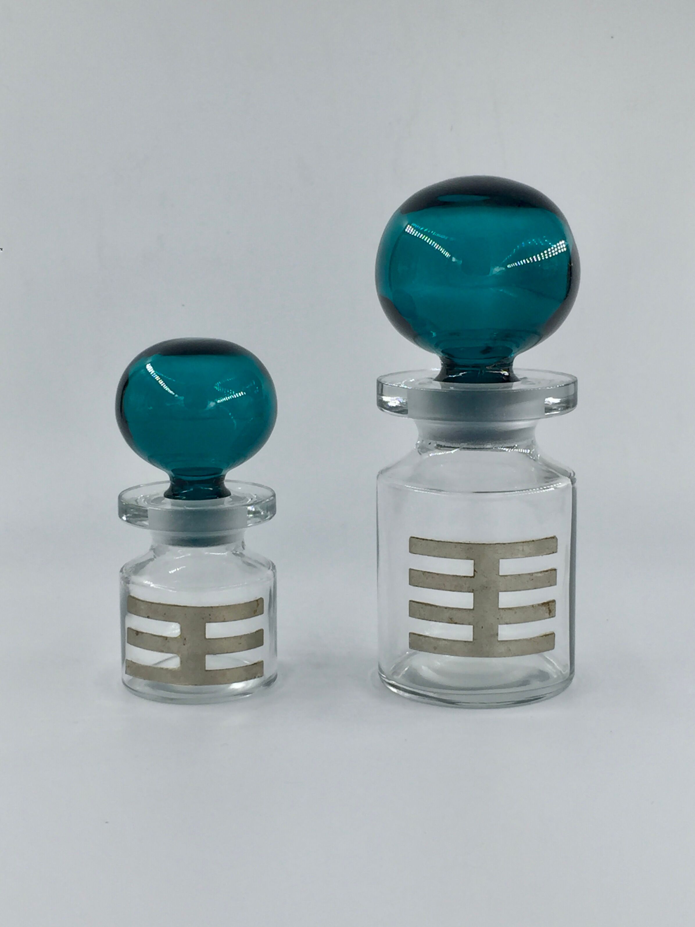 Two vintage 70s glass and metal bottles