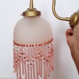 Pink glass wall lamp with garland of pearls