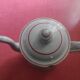 White enamelled sheet metal coffee maker with red and blue patterns