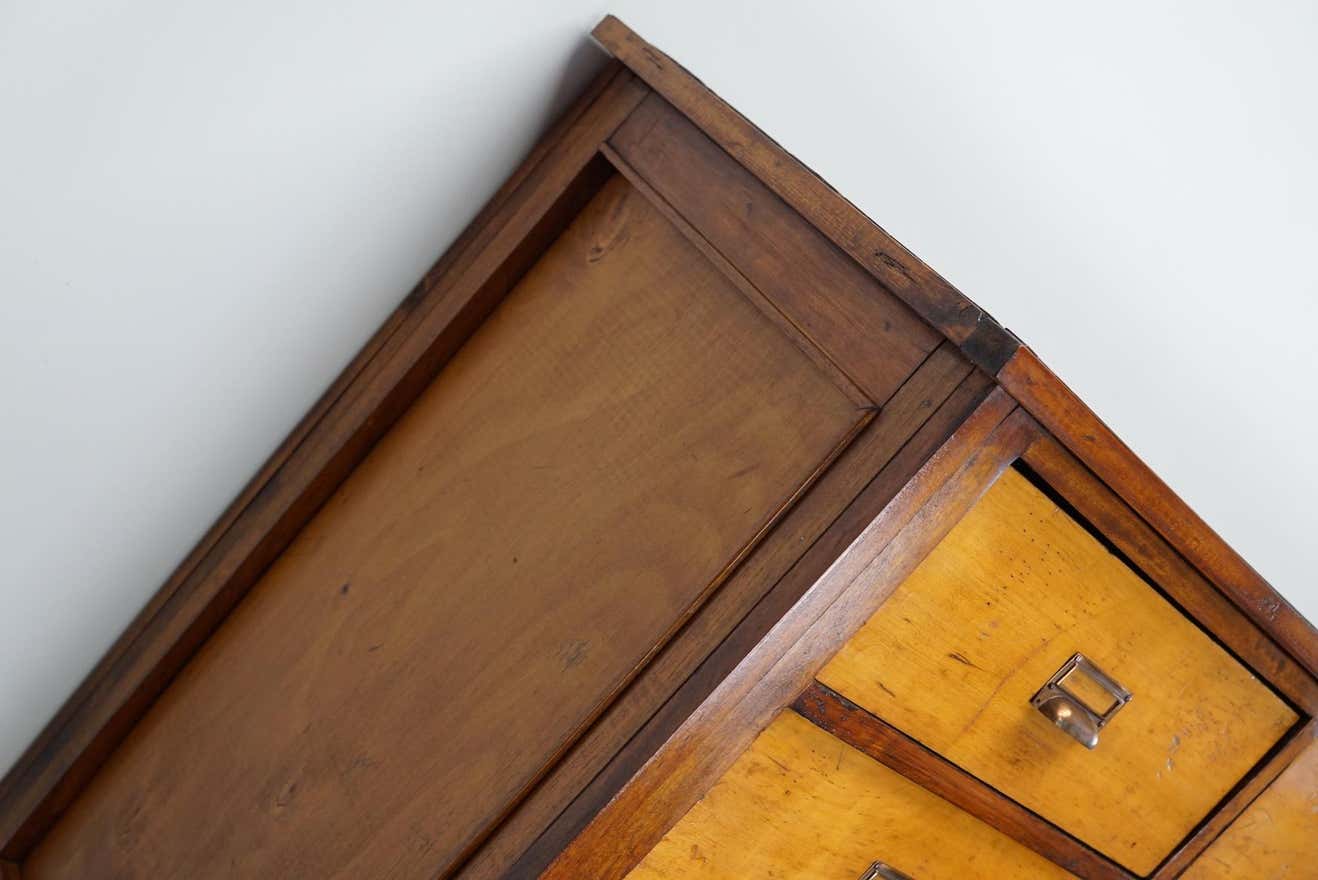 School cabinet bank of vintage Dutch drawers in mid-twentieth century pine