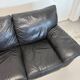 Two-seater black leather sofa — postmodern design