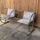 Vintage brass and glass bench, yellow colour, two-seater, tubular design from the 1950s.