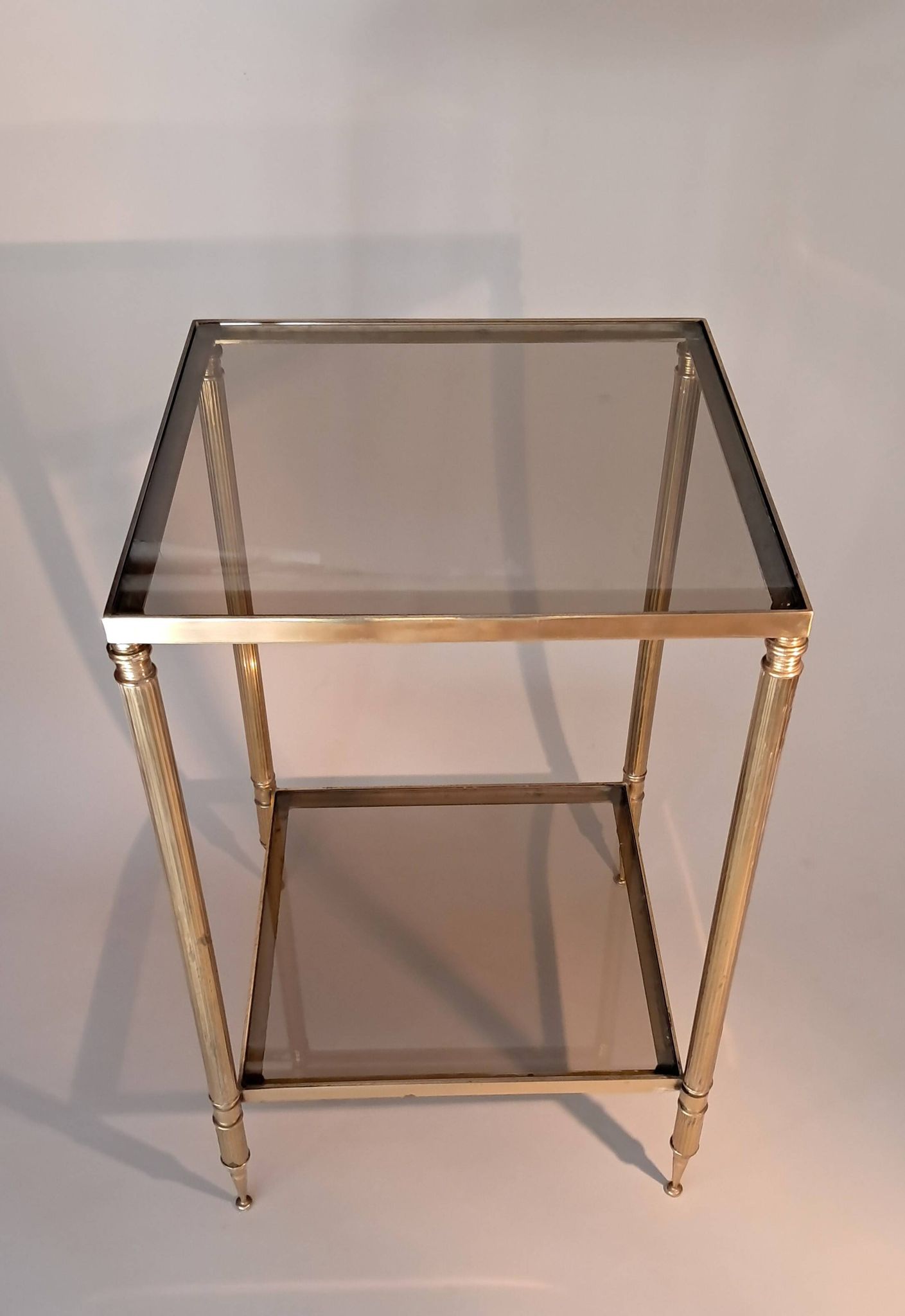 Gilded brass and smoked glass end table, 1960s.