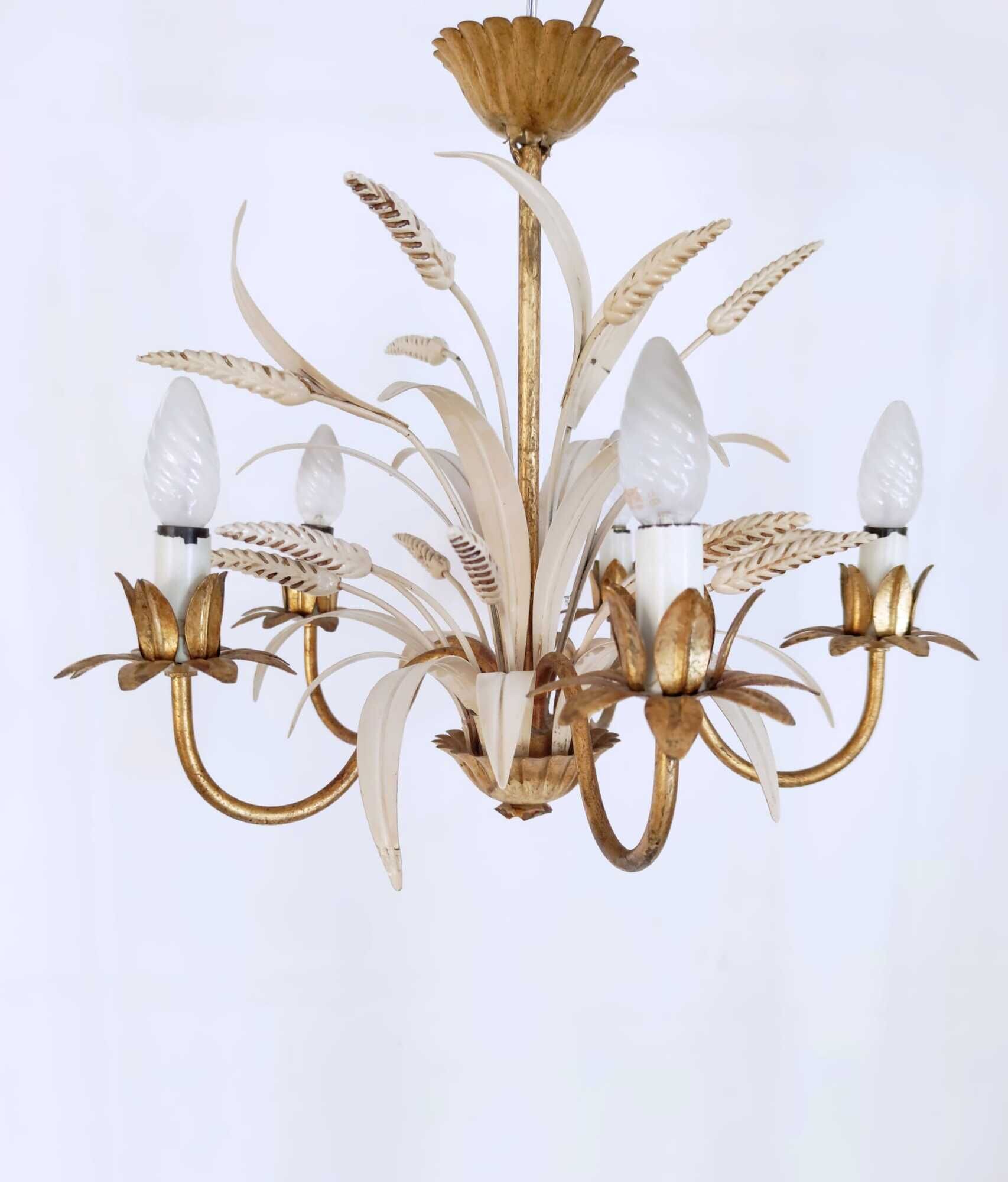 Vintage wrought iron chandelier decorated with golden and beige reeds