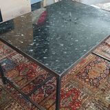 Coffee table with top in silver granite and welded steel base.