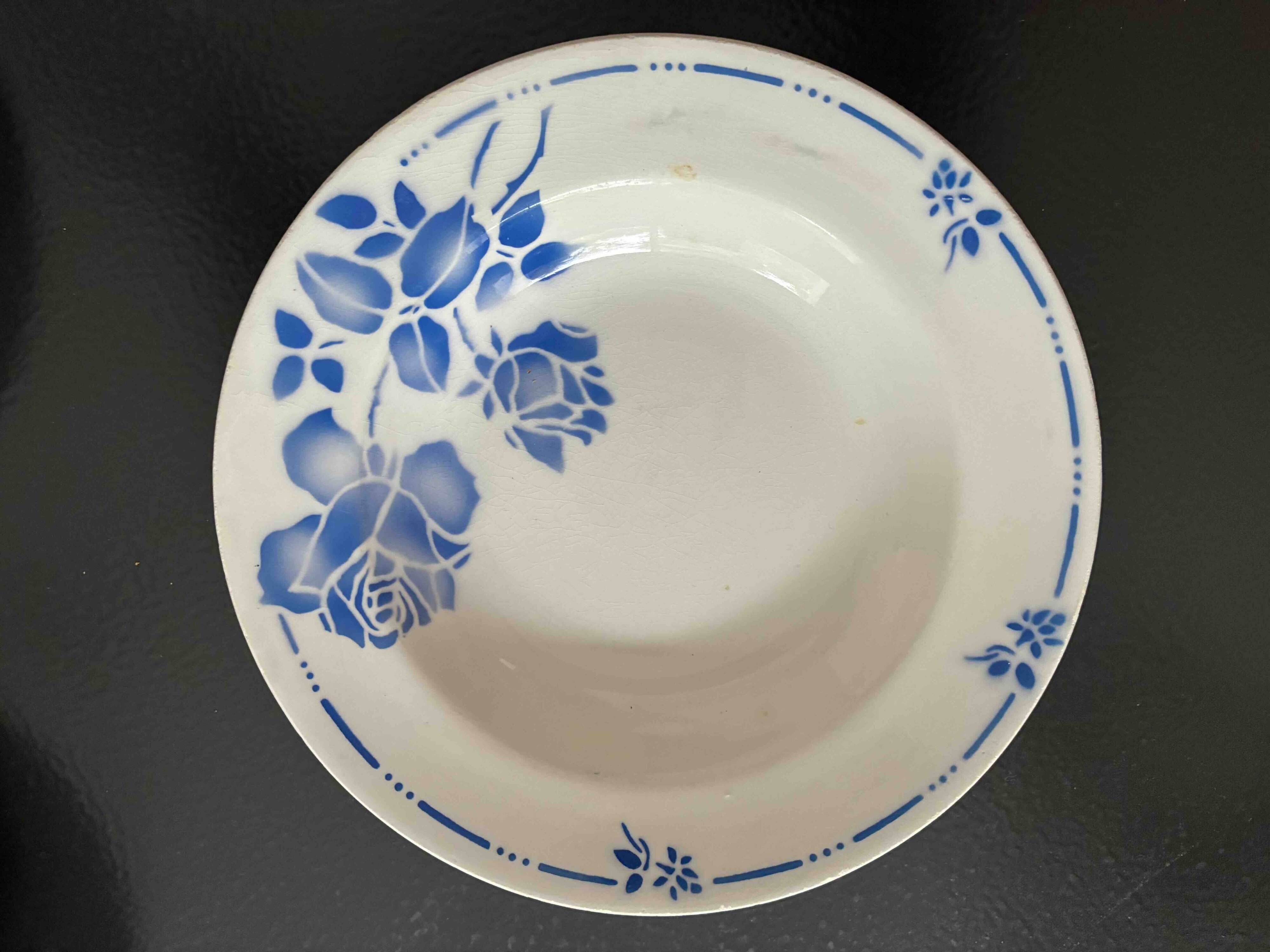 Set of 9 vintage deep plates with blue patterns.