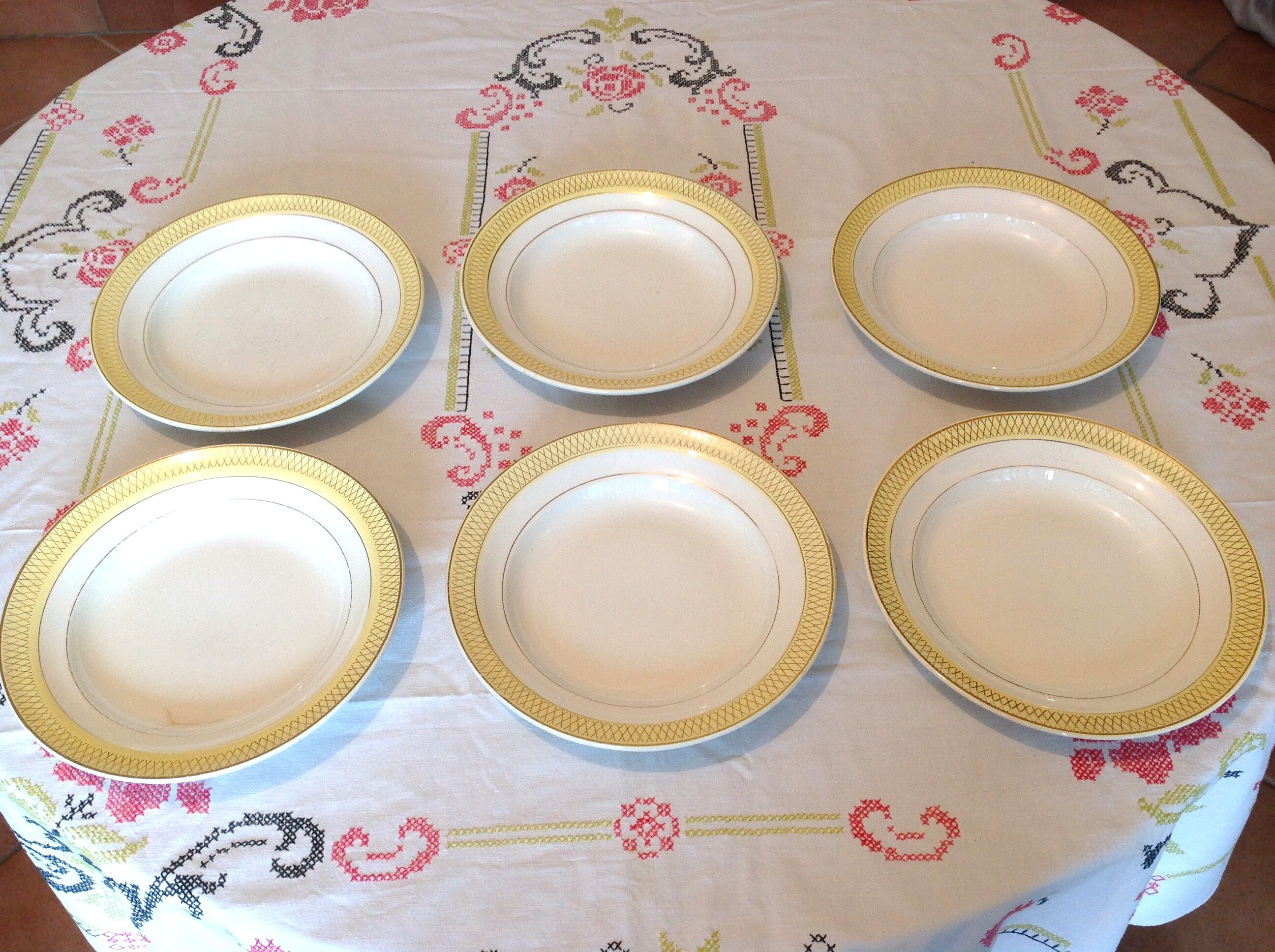 Six white hollow plates on board yellow Monaco 60