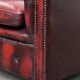 Red English cowhide Chesterfield armchair finished with decorative nails