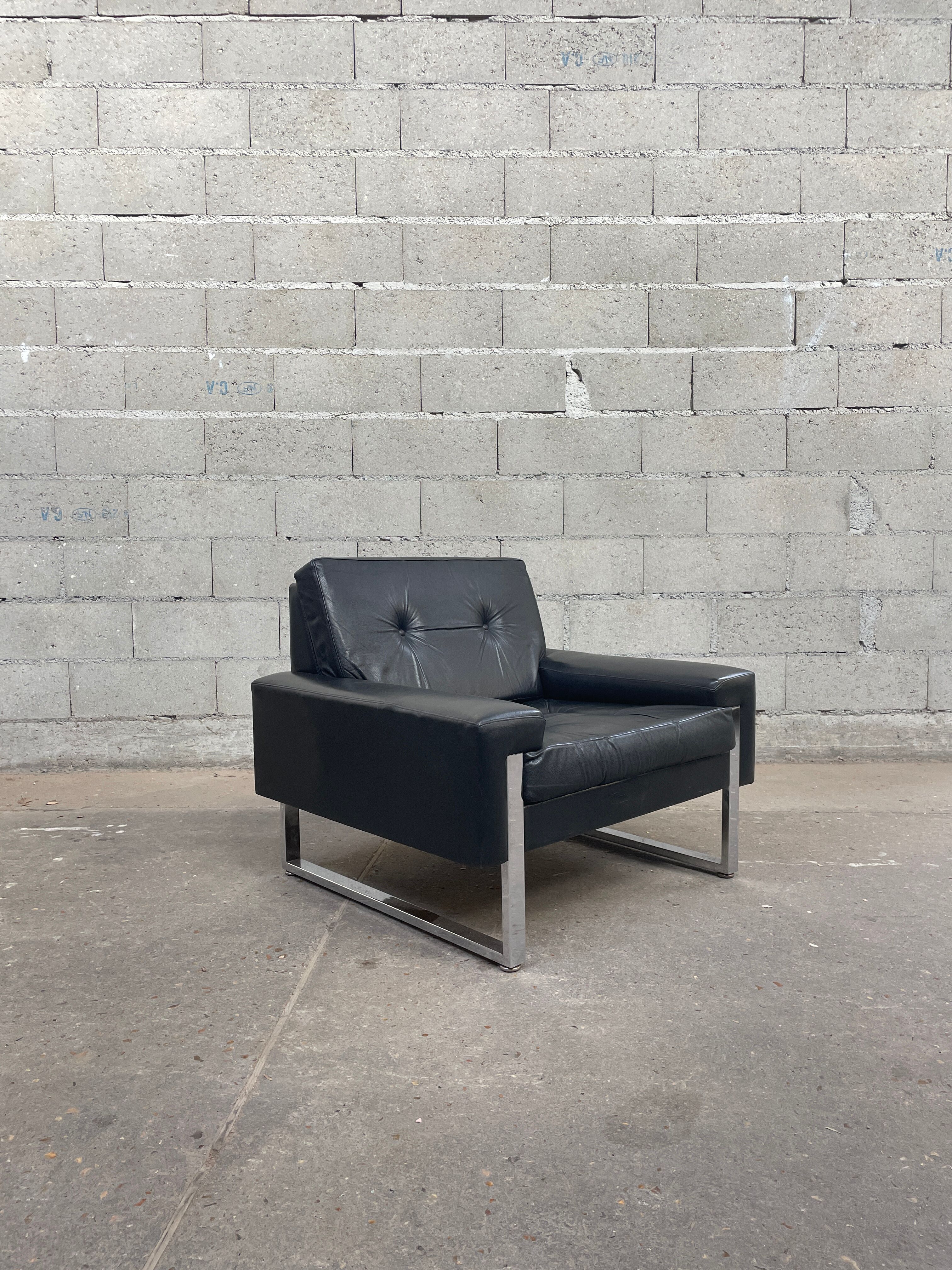 Pair of black leather armchairs