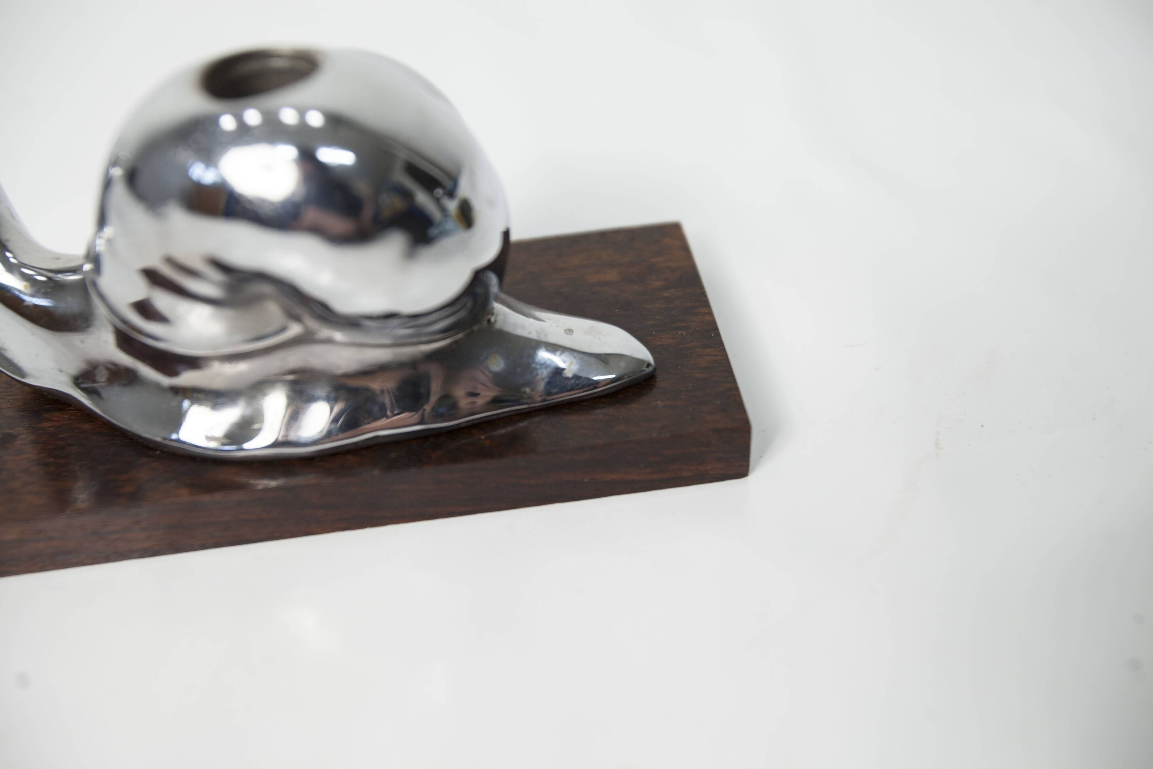Silver snail candlestick on a teak base 1960