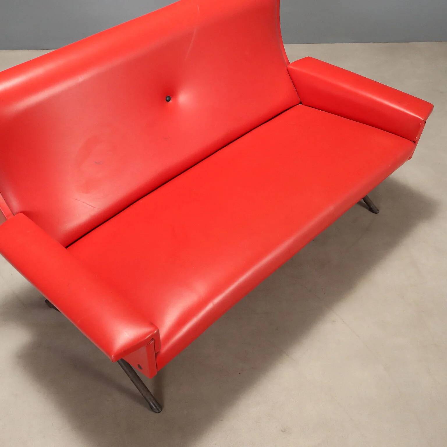 Vintage red faux leather sofa from the 1960s.