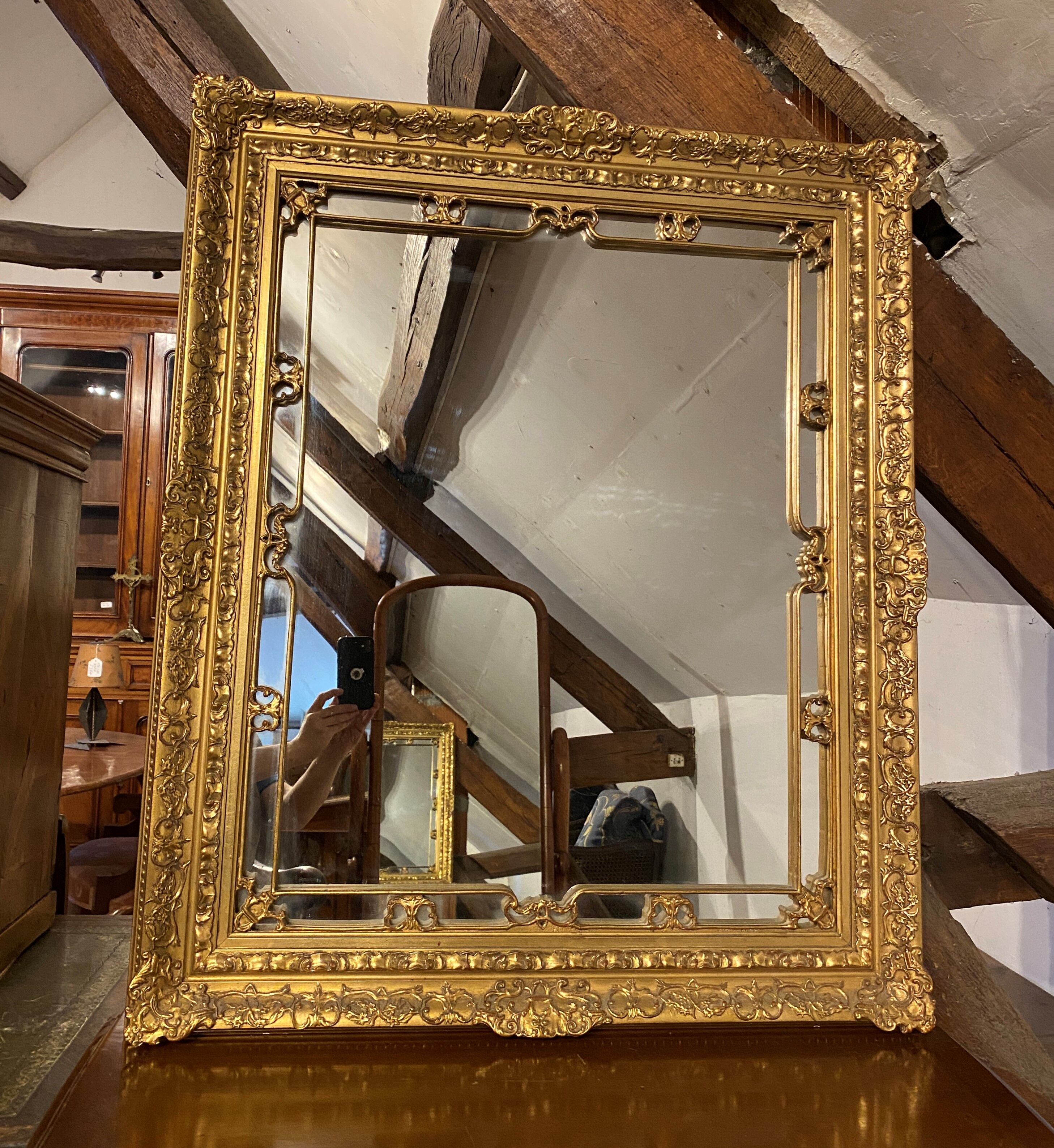 Wooden mirror with gilded stucco