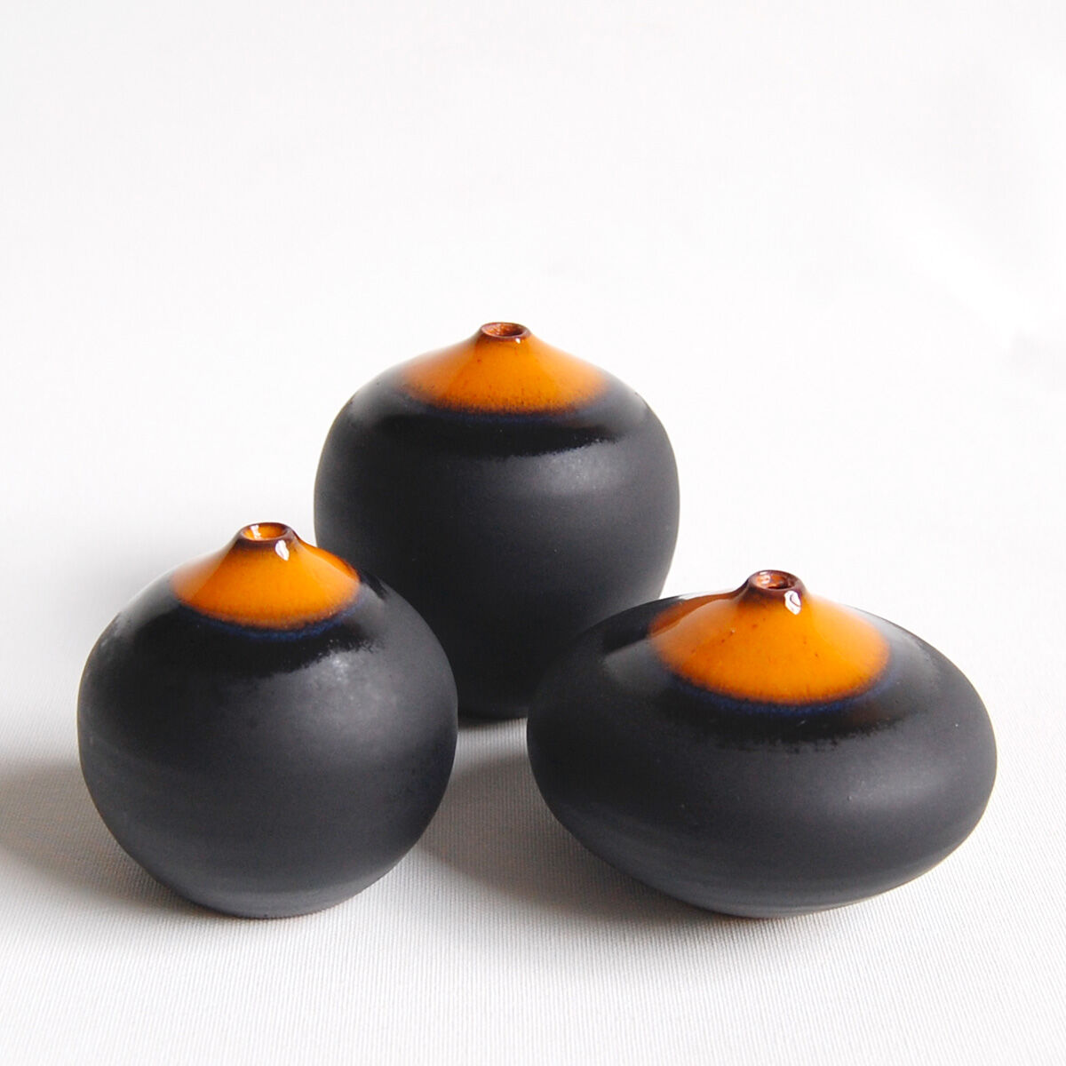 Trio of miniature black and orange ceramics Antonio Lampecco