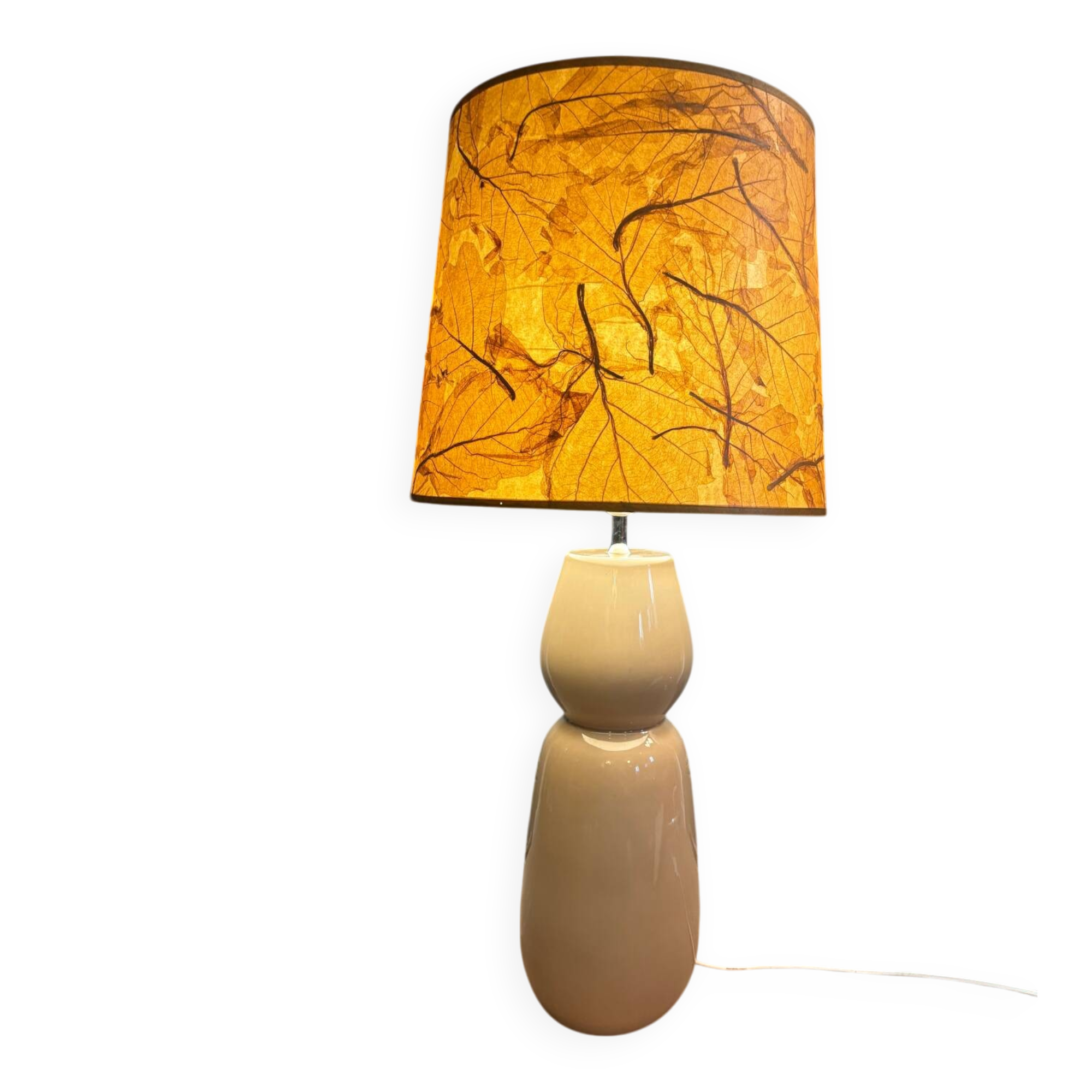 Large beige ceramic table lamp with a vintage shade.