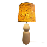 Large beige ceramic table lamp with a vintage shade.
