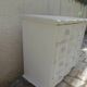 A beautifully crafted crossbow-shaped chest of drawers, finished in pearl grey with a whitewashed top.