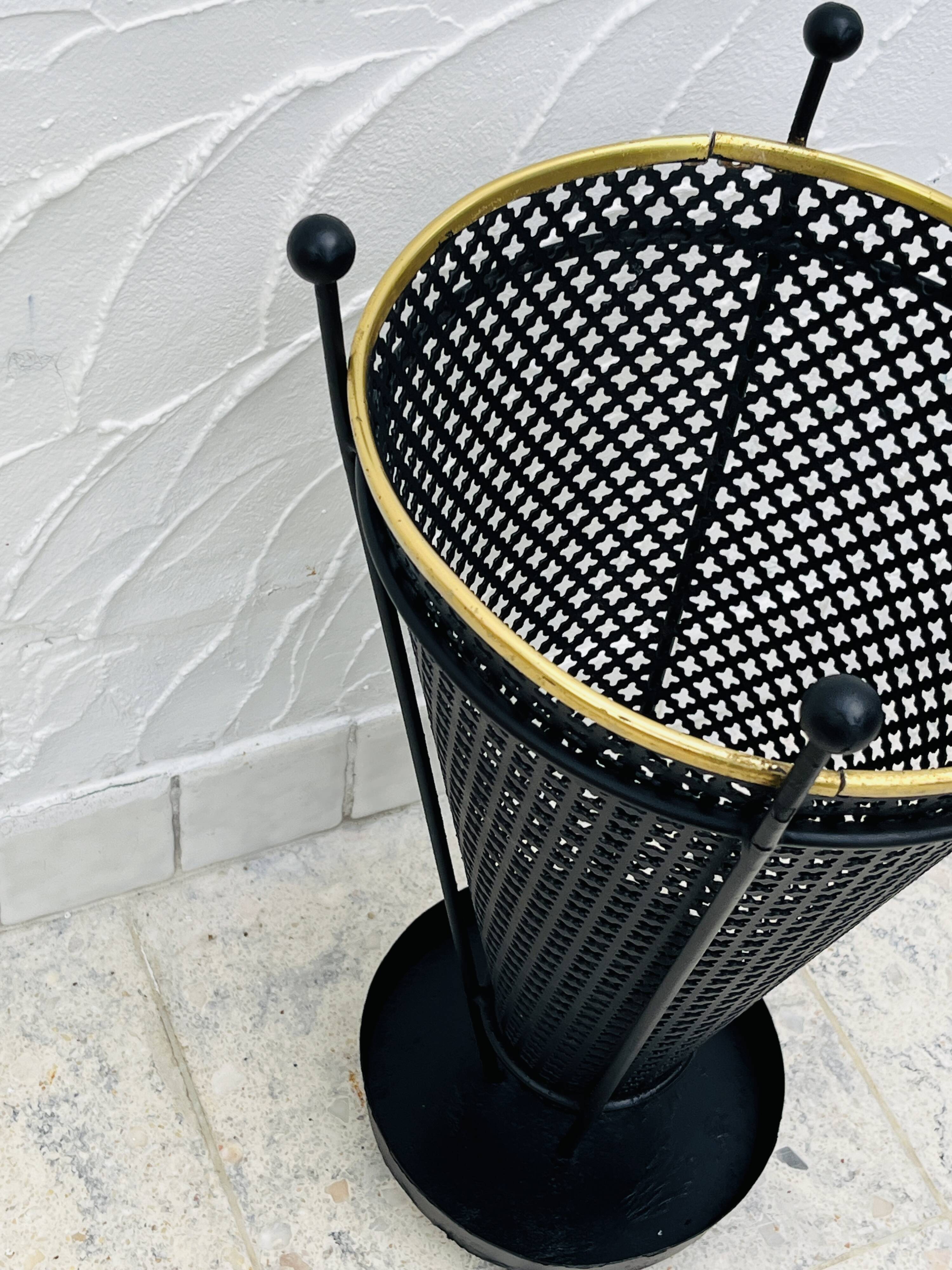 Vintage black perforated metal and brass umbrella stand