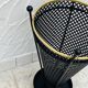 Vintage black perforated metal and brass umbrella stand