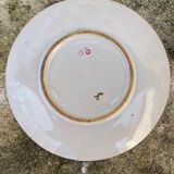 Old plate with flower and rooster pattern