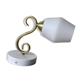 Swan neck wall light in brass with a white glass shade.