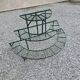 Old half-moon wrought iron plant holder