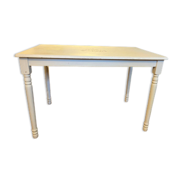 Farm table with a cream patina.