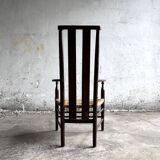 Dark brown solid wood Arts & Crafts armchair with natural rush seat and high back
