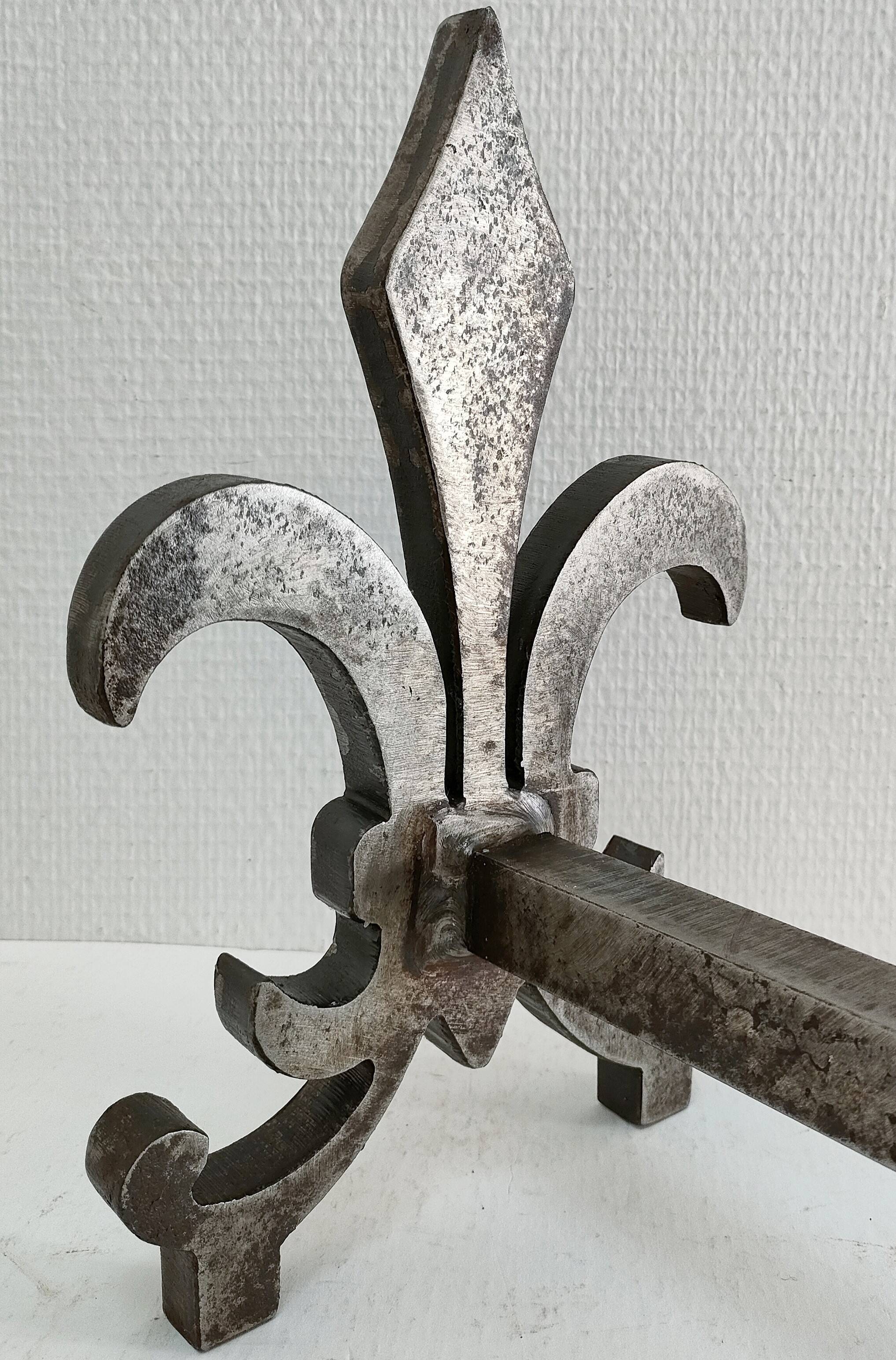 Pair of vintage steel fleur-de-lys andirons