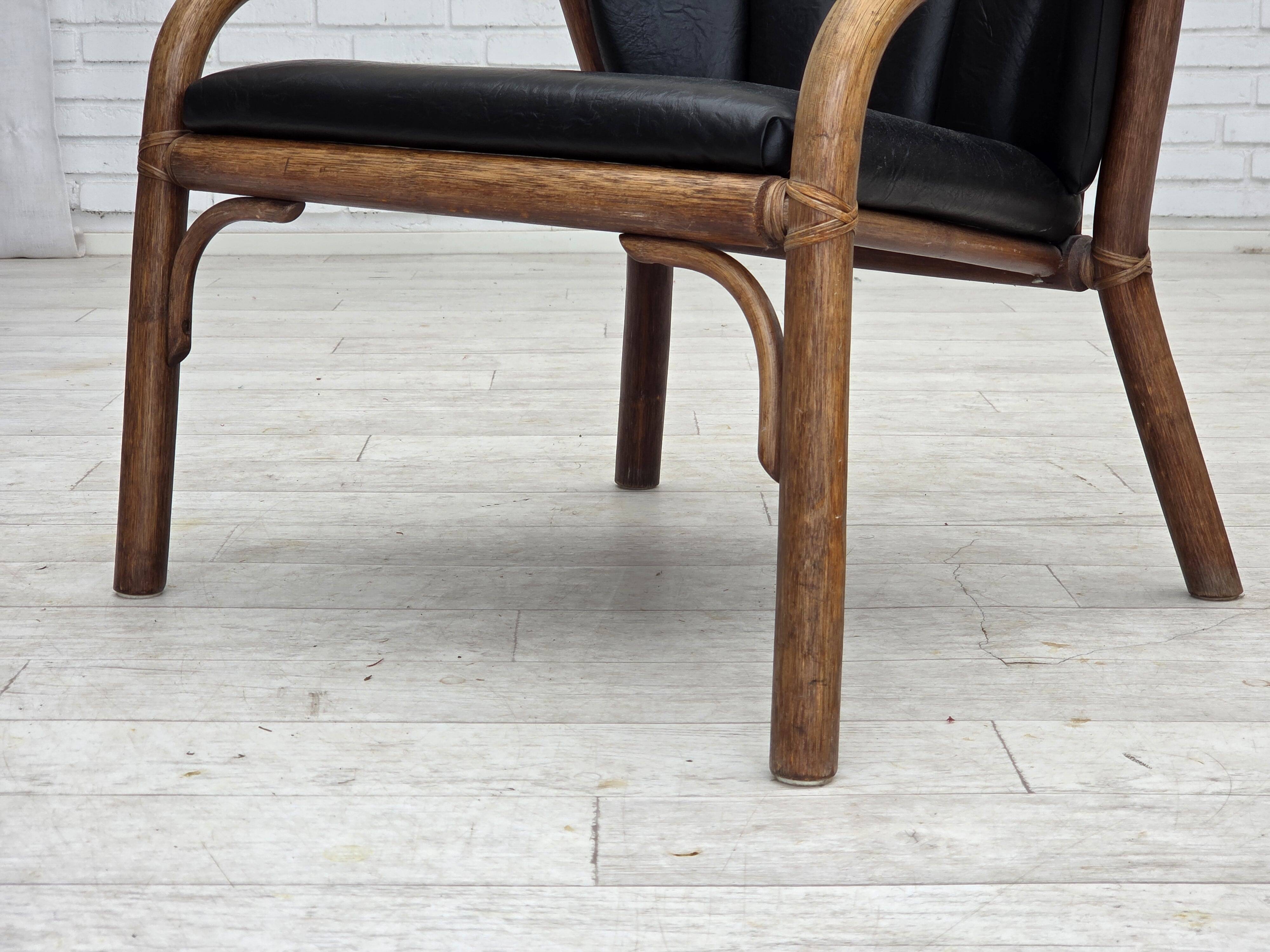 1970s, Danish armchair, rattan, black artificial leather.