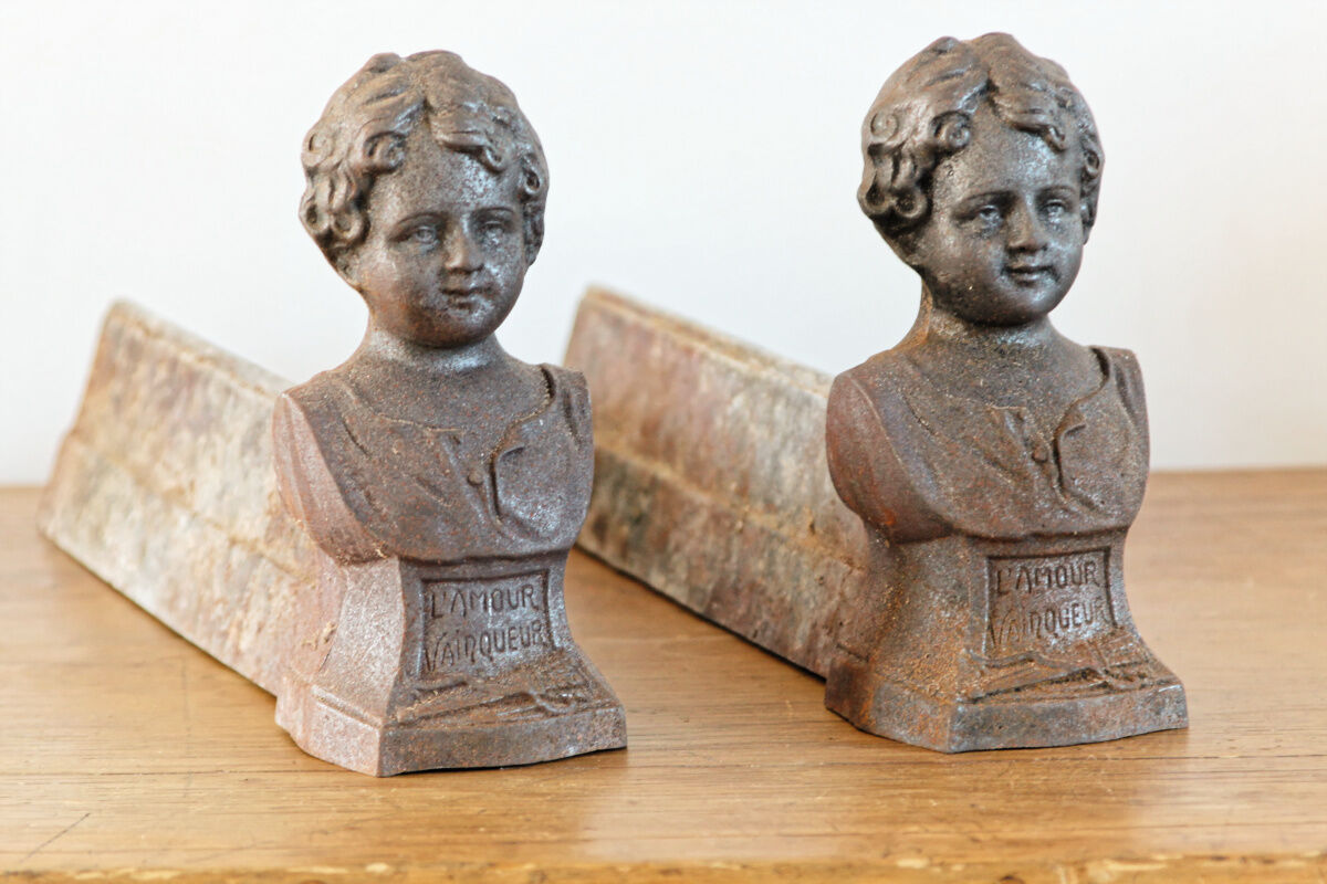 Pair of cast iron chenets, Love victorious